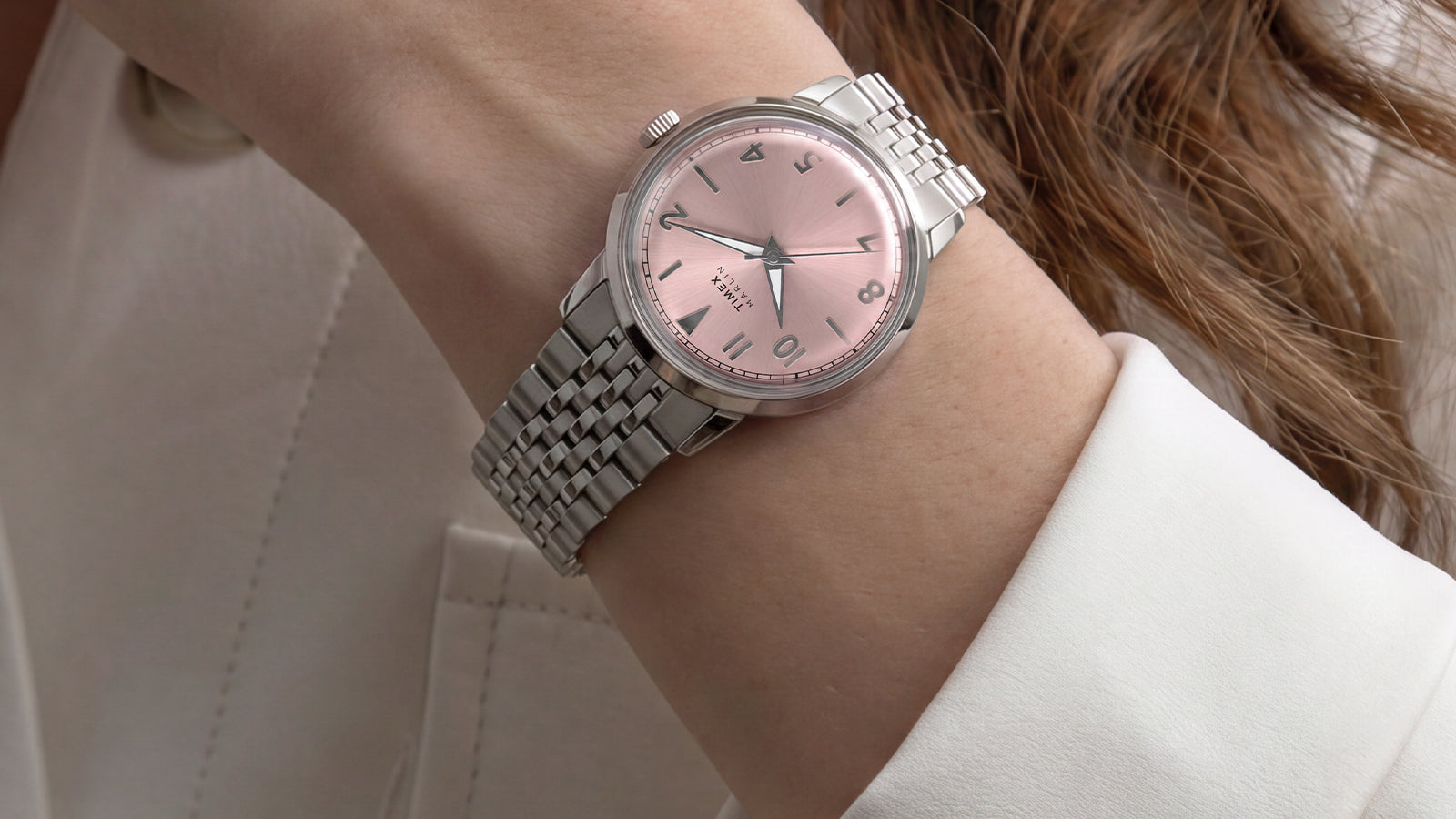 Timex Marlin Quartz with a pink sunray dial and stainless steel bracelet worn on the wrist.