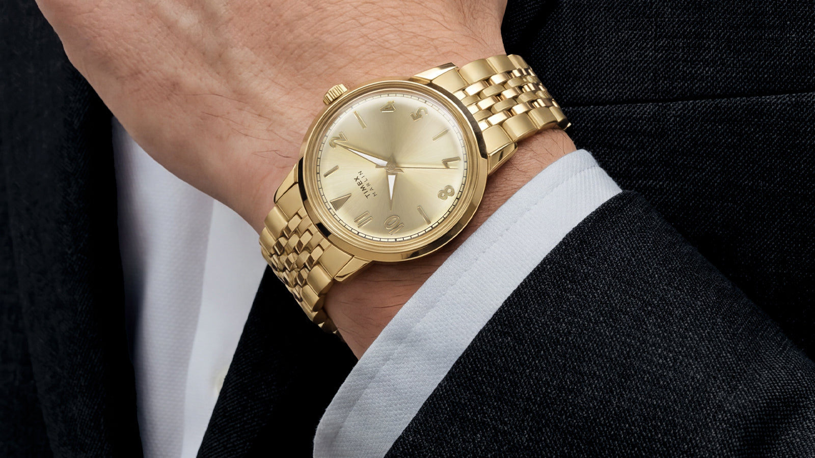 Close-up of the Timex Marlin Quartz with a champagne sunray dial and gold-tone stainless steel bracelet worn on the wrist.