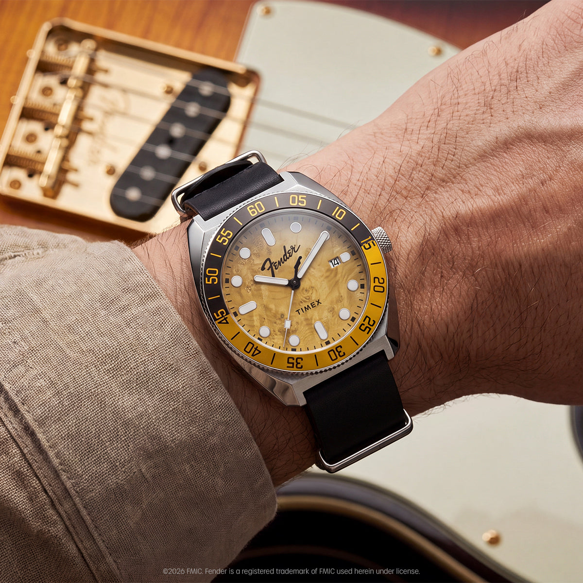 Fender x Timex Automatic watch worn on the wrist beside a Fender electric guitar.
