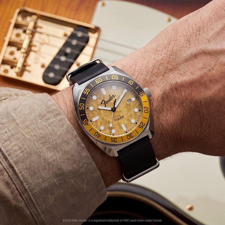 Fender x Timex Automatic watch worn on the wrist beside a Fender electric guitar.