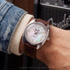 Fender x Timex watch worn on the wrist with a Fender amplifier in the background.