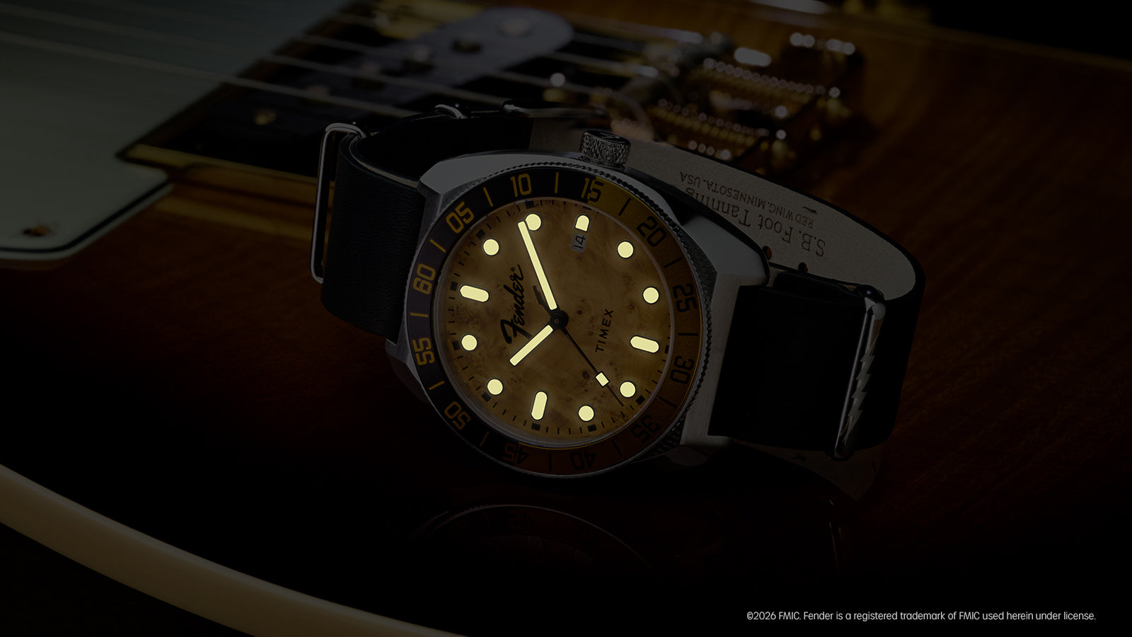 Fender x Timex Automatic displayed in low light with glowing hour markers and hands.