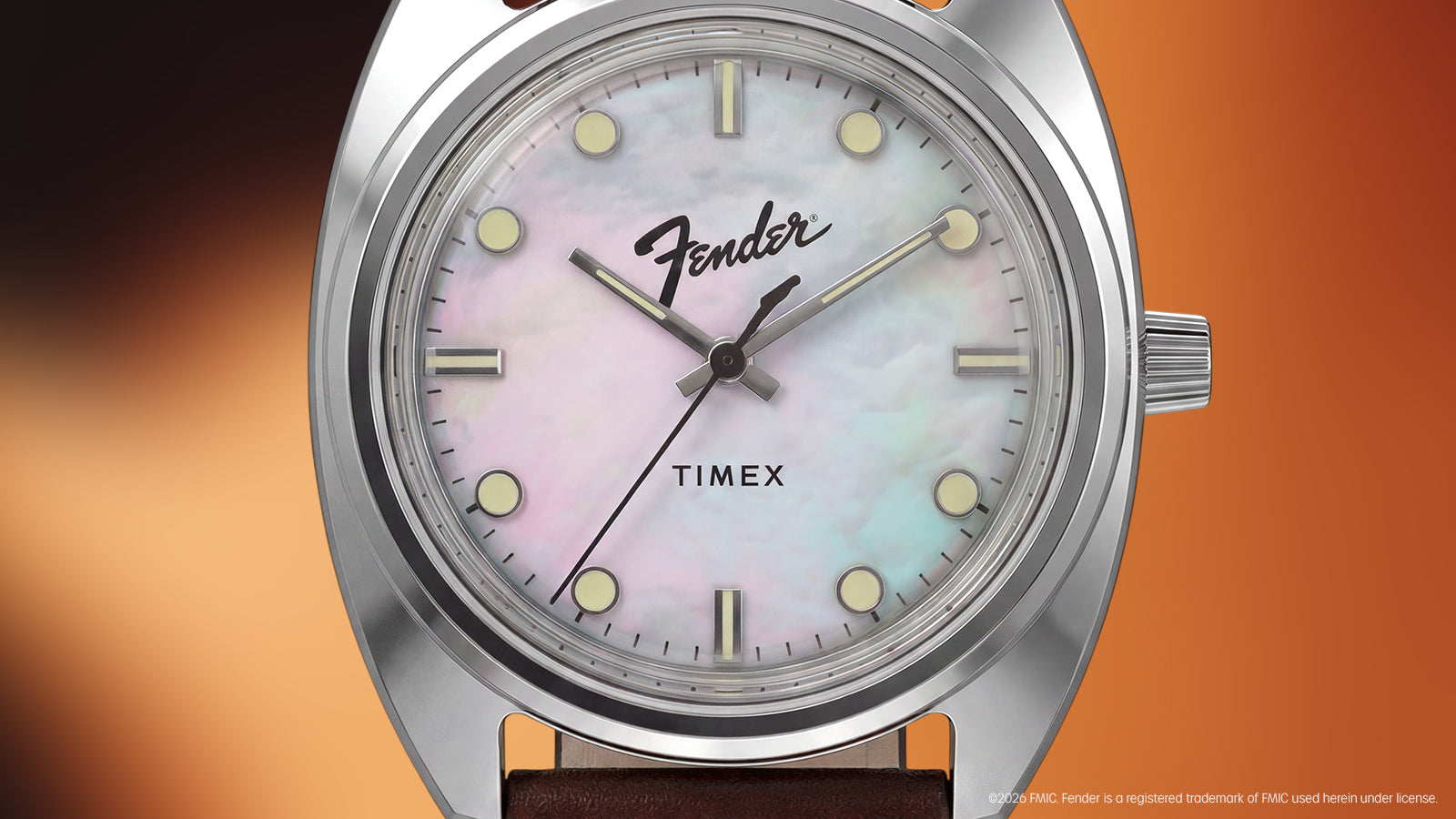 Detailed close-up of the mother-of-pearl dial with Fender and Timex logos, luminous hour markers, and silver-tone hands.