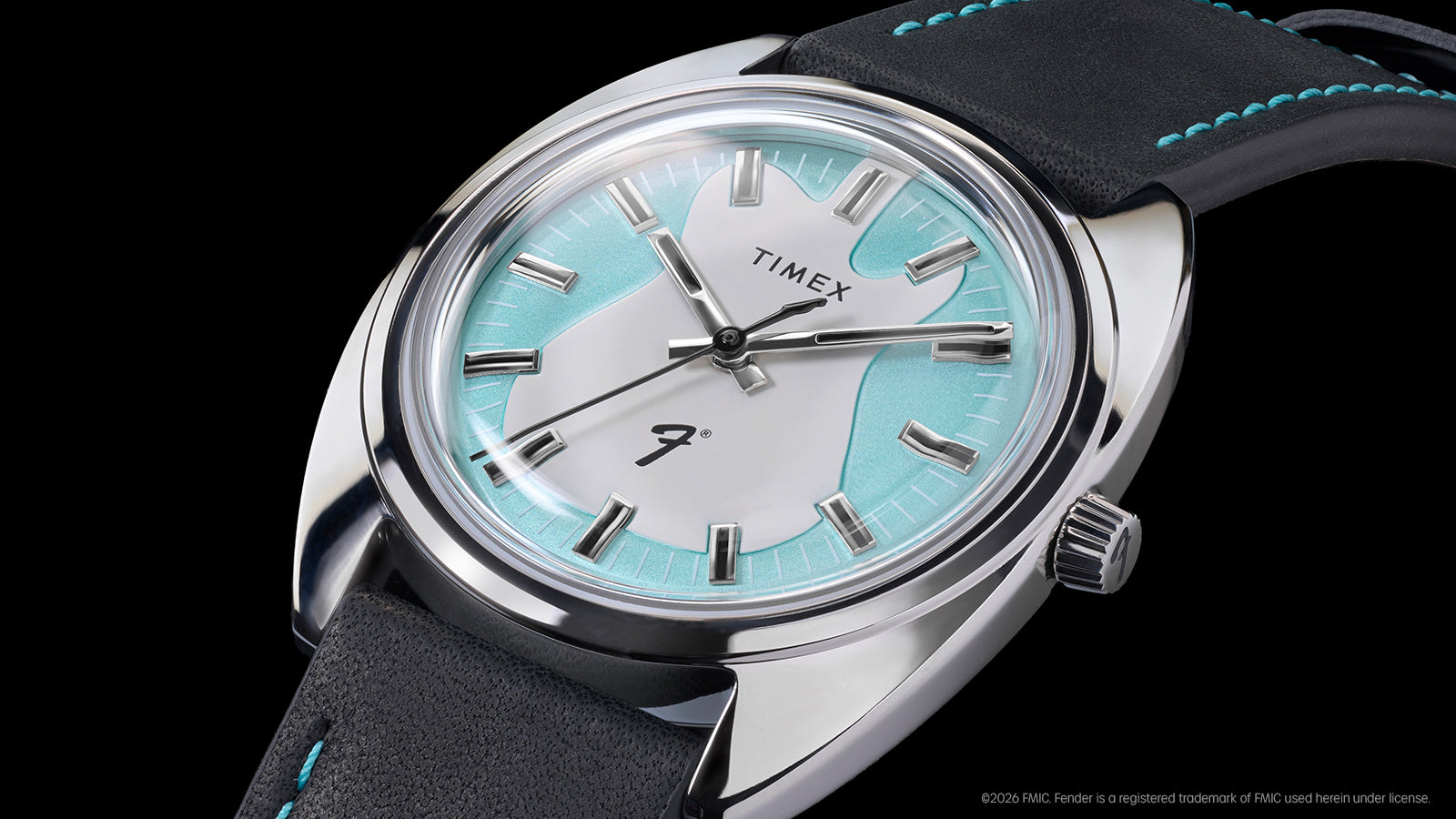 Angled close-up of the Fender x Timex watch highlighting its aqua-accented dial, silver-tone case, and guitar motif.
