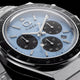 Close-up of the Q Timex Chronograph’s ice-blue dial, black subdials, date window, and tachymeter bezel.