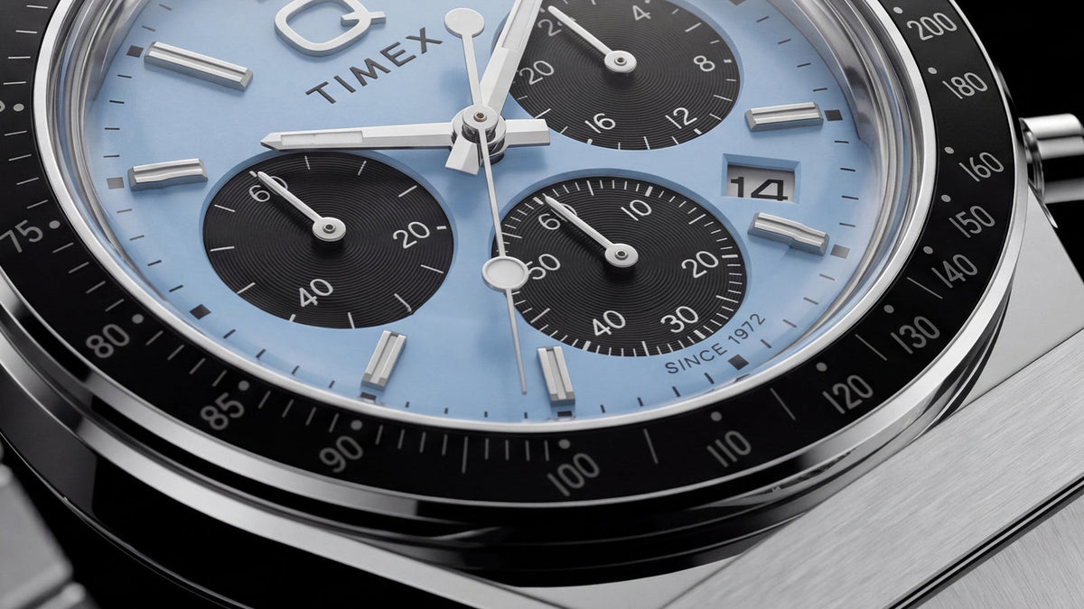Detailed close-up of the Q Timex Chronograph’s ice-blue dial, three black subdials, and date window.