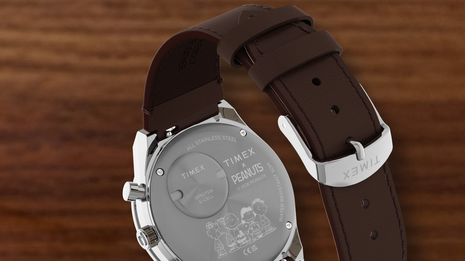 Back view of the Peanuts® x Q Timex Chronograph featuring an engraved Peanuts character design and a brown leather strap.
