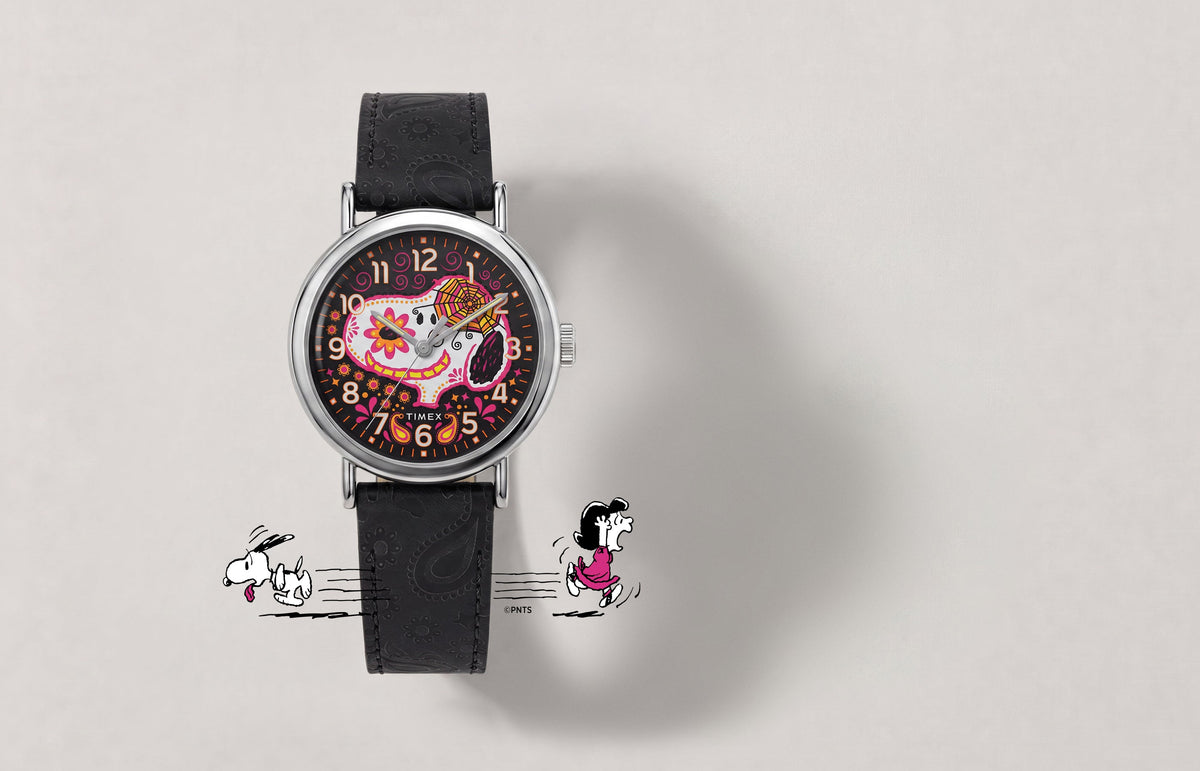 Peanuts® x Timex Weekender® Day of the Dead watch with a black embossed leather strap and colorful Snoopy sugar-skull dial.