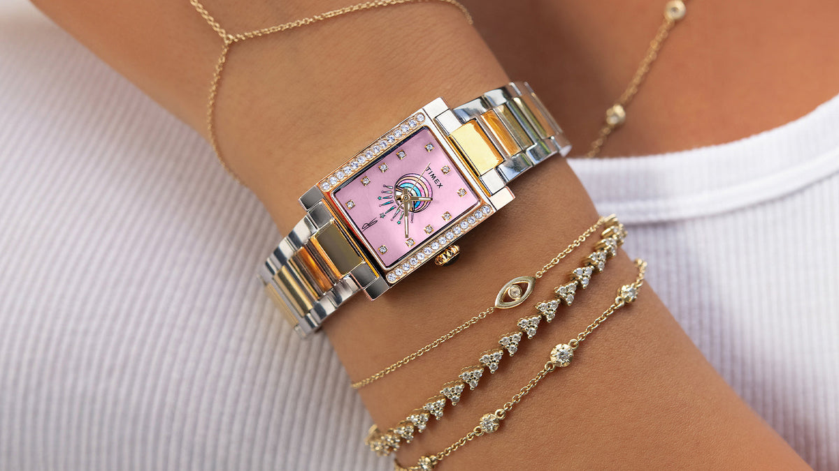 Timex x Jacquie Aiche Éclat two-tone watch styled with delicate gold and diamond bracelets.