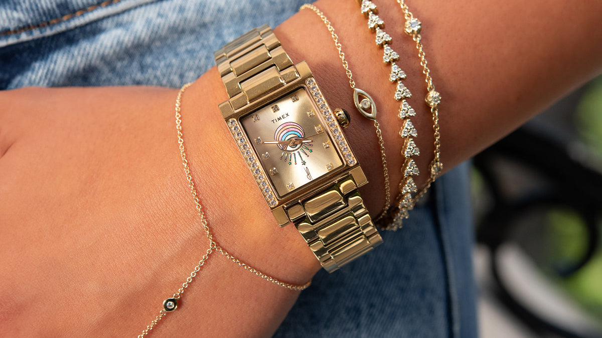 Gold-tone Timex x Jacquie Aiche Éclat watch styled with delicate gold and crystal bracelets.