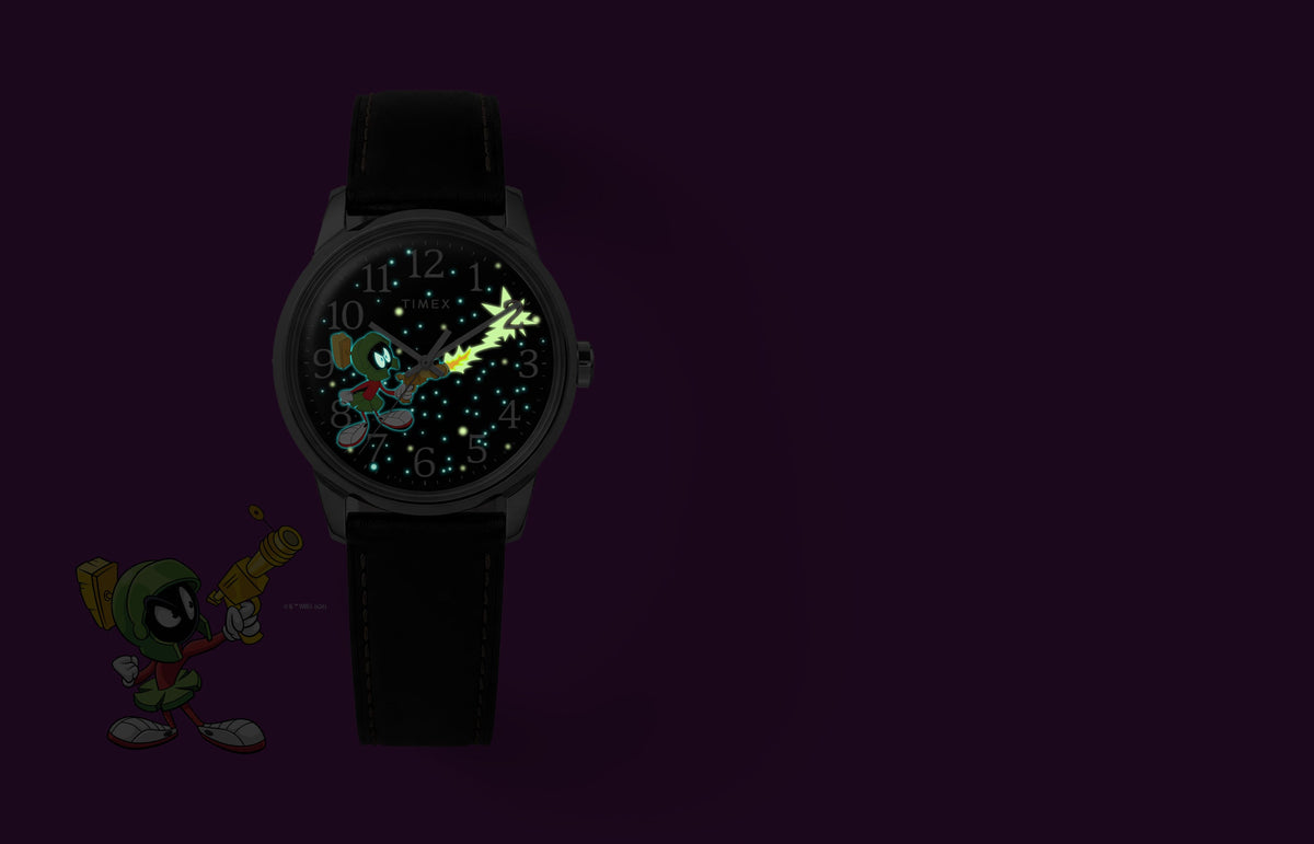TW2Y99300 Marvin the Martian x Timex Easy Reader® watch with glowing stars, character details, and a ray-gun blast beside Marvin artwork.