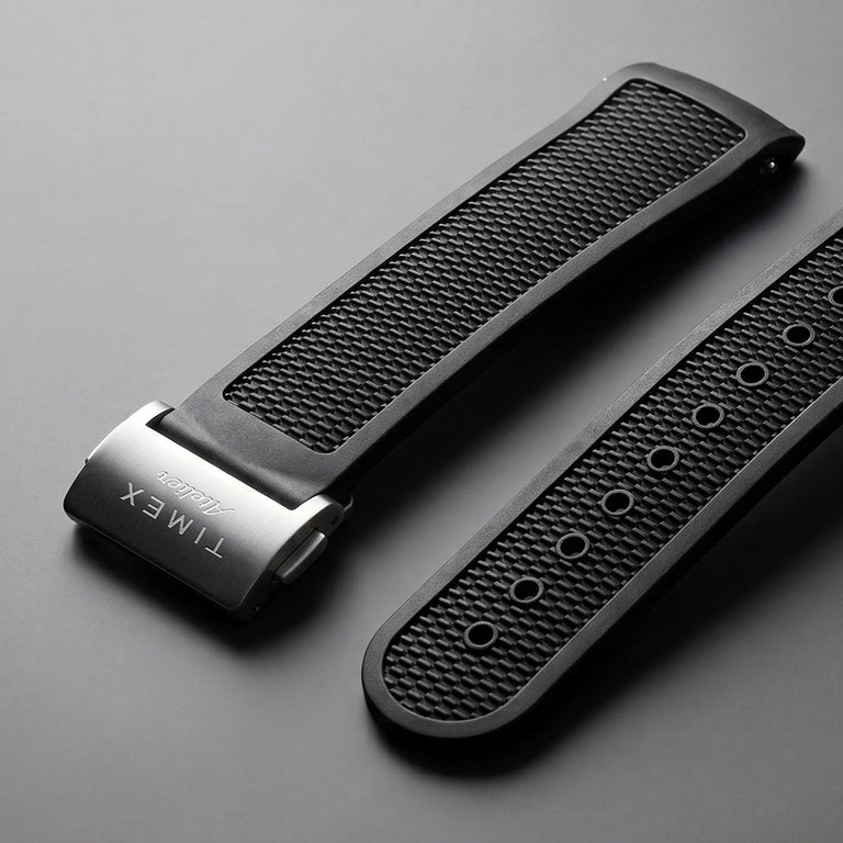 Two textured black rubber watch straps with a brushed stainless-steel Timex Atelier clasp.