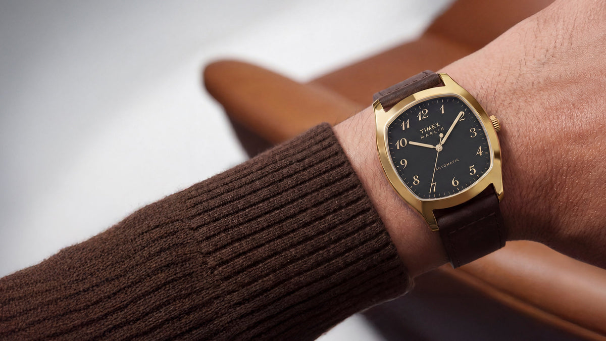 TW2Y84500 Marlin® Chatham Automatic watch worn with a brown knit sweater, featuring a black dial and brown leather strap.