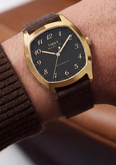 TW2Y84500 Marlin® Chatham Automatic watch worn with a brown knit sweater, featuring a black dial and brown leather strap.