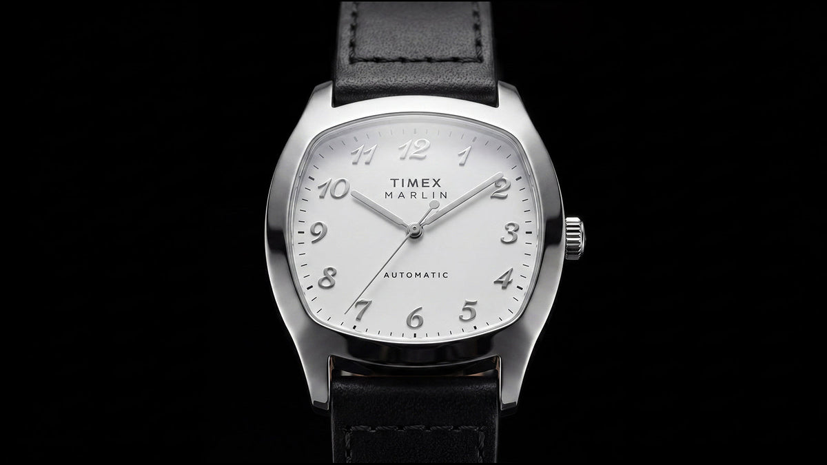 TW2Y84300 Front close-up of the Marlin® Chatham Automatic watch with raised Arabic numerals and a black leather strap against a black background.