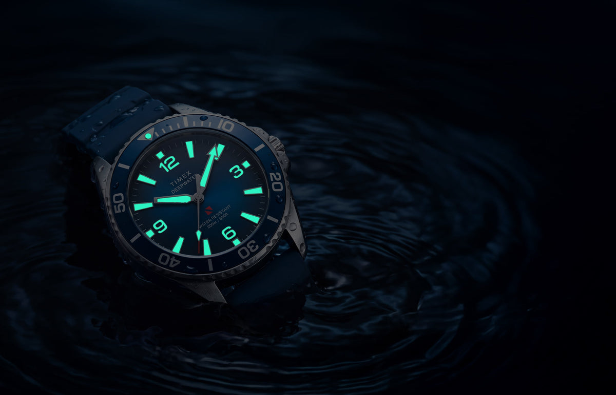 TW3A01900 Deepwater Arctic 200 watch in dark water with luminous hands and hour markers glowing aqua.