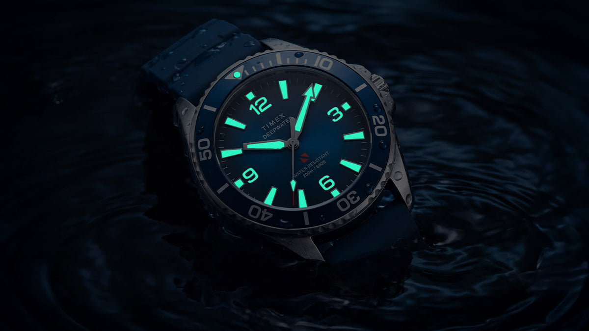 TW3A01900 Angled close-up of the Deepwater Arctic 200 watch with glowing aqua hands and hour markers.