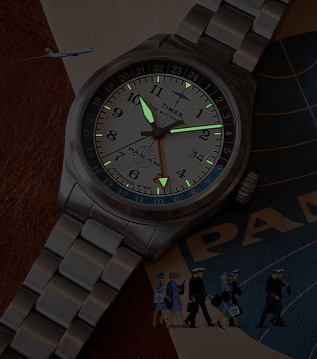 TW2Y94600 Pan Am x Timex Waterbury Automatic GMT watch with luminous hands and hour markers glowing in the dark.