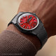 TW2Y99700 Harry Potter x Q Timex watch with a red Sorcerer’s Stone-inspired dial and black bracelet worn on the wrist.