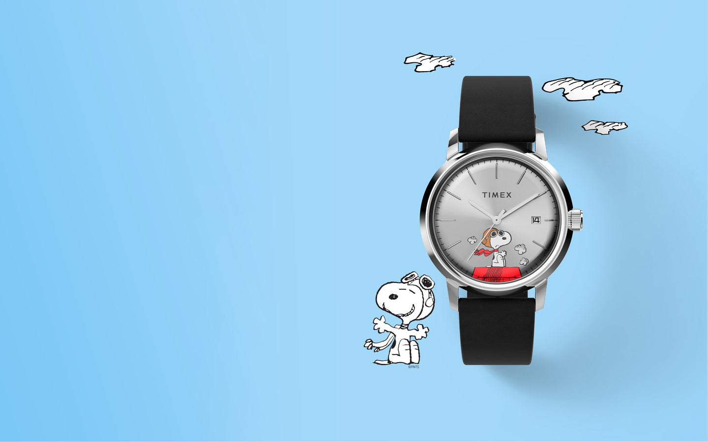 A playful and stylish image featuring the Timex Snoopy Flying Ace watch against a light blue background with cartoon-style clouds. The watch has a silver dial with an illustration of Snoopy dressed as a World War I flying ace, sitting atop his iconic red doghouse. The black strap complements the sleek design. To the left, an additional Snoopy illustration adds charm to the composition. The layout emphasizes the aviation theme while maintaining a clean and modern aesthetic.