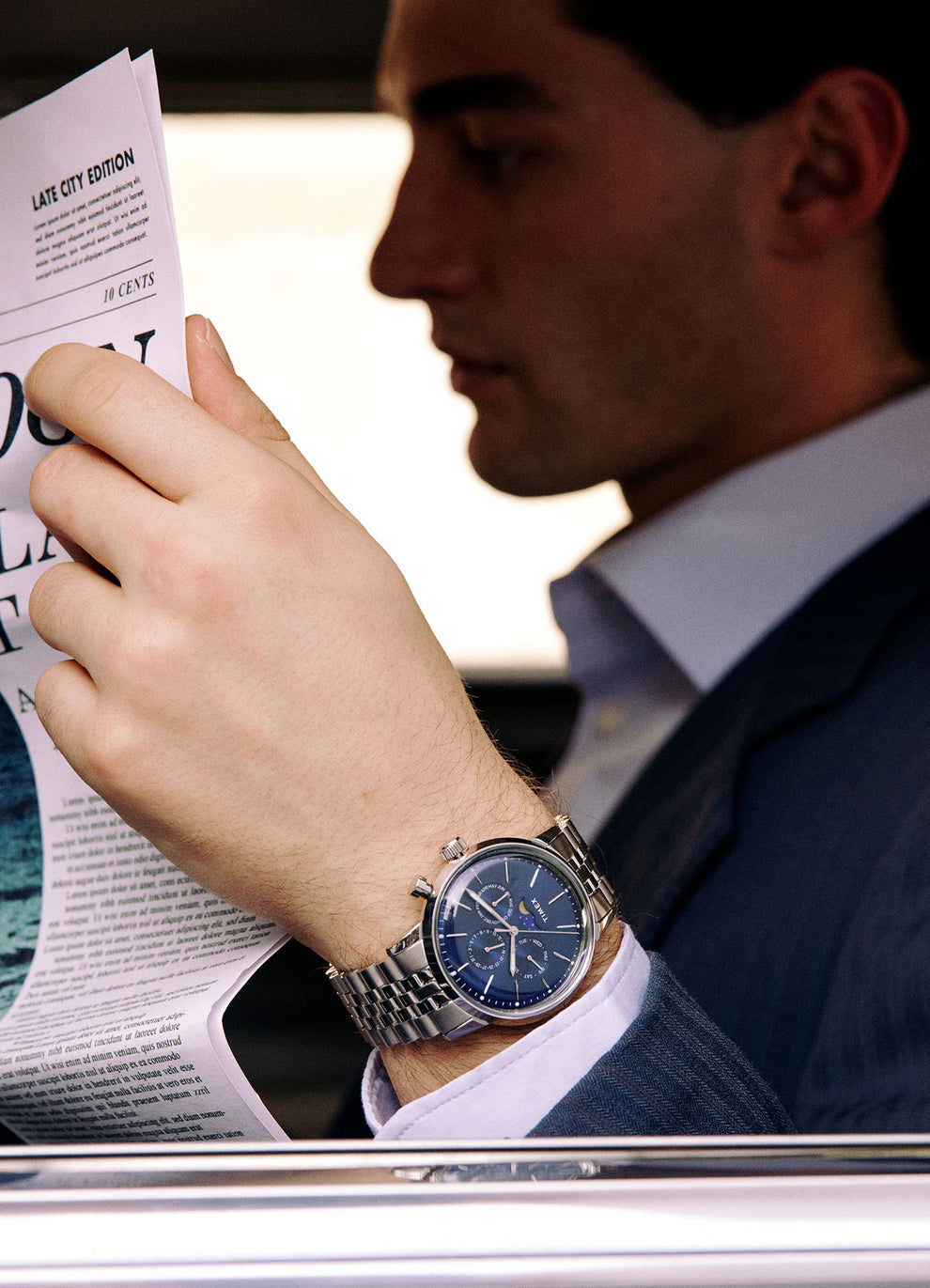 Man wearing the Marlin Moon Phase Blue dial watch whilst reading the newspapaer