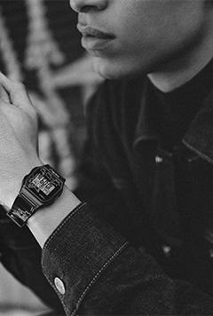 A man showing Timex T80 x Keith Haring 34mm Resin Strap Watch in his wrist