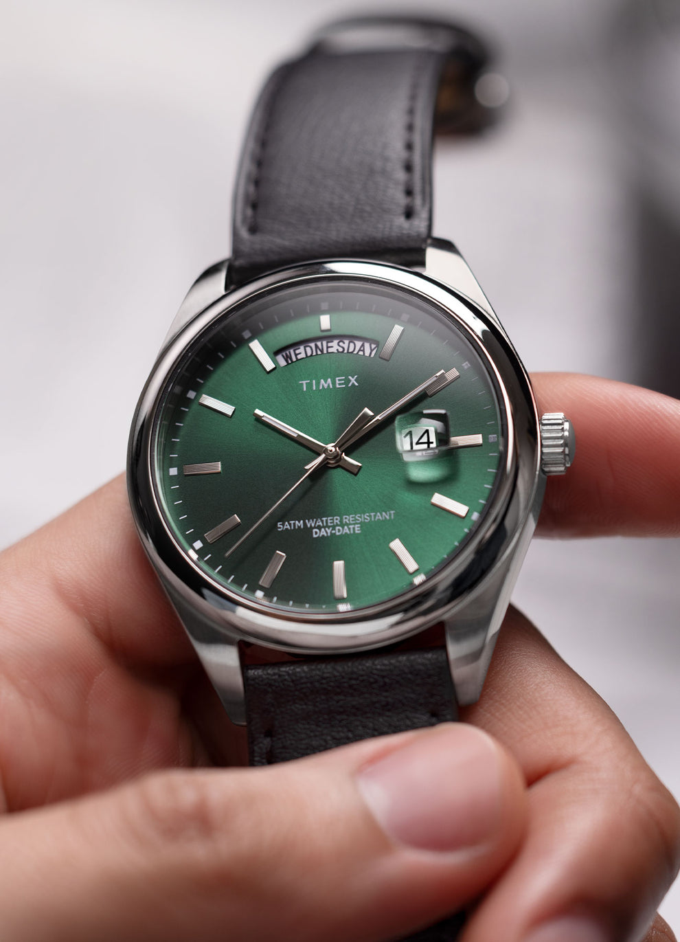 Man Holding Timex Legacy Green Dial Leather Strap Watch.