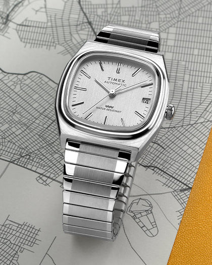Silver Timex watch on a map background