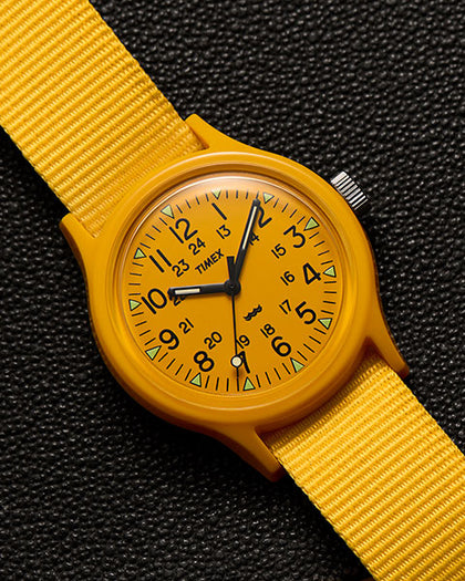 MK1 with a yellow strap on a black background