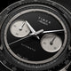 Close-up of the Timex Atelier Chronograph Automatic M1a Ti black dial featuring contrasting silver-tone sub-dials, applied markers, and polished chronograph hands.