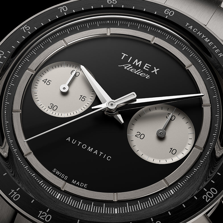 Close-up of Timex Atelier Chronograph Automatic Ti M1a black enamel dial with dual subdials and polished hands