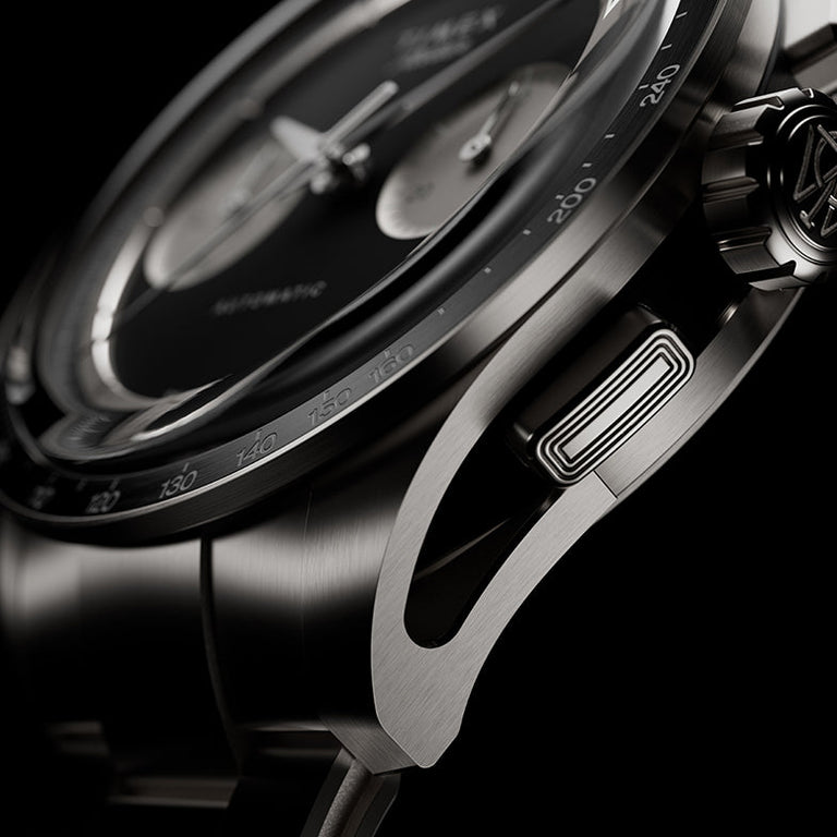 Side detail of Timex Atelier Chronograph Automatic Ti M1a titanium case showing tachymeter bezel, crown, and chronograph pusher
