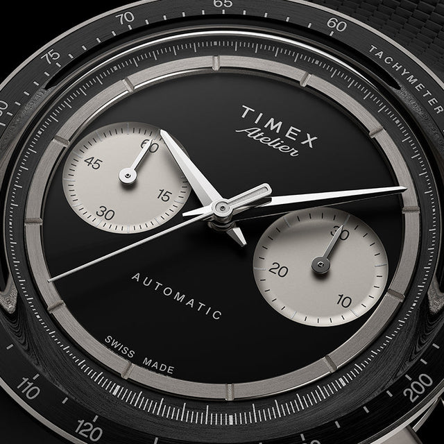 Close-up of Timex Atelier Chronograph Automatic Ti M1a black dial with dual subdials and tachymeter scale