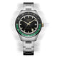 Front view of the Timex Atelier GMT Première M1a watch with a black dial, green GMT scale, and stainless-steel bracelet.