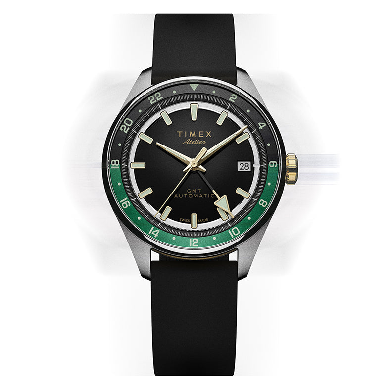 Front view of the Timex Atelier GMT Première M1a watch with a black dial, green GMT scale, and black rubber strap.