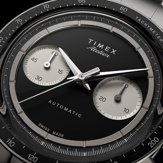 Close-up of the Timex Atelier Chronograph Automatic M1a Ti black dial featuring silver-tone sub-dials, applied markers, and polished chronograph hands.