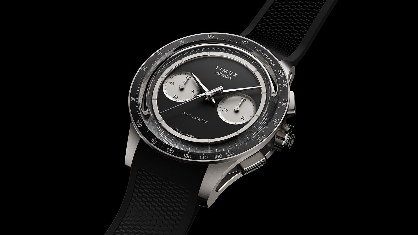 Timex Atelier Chronograph Automatic M1a Ti luxury titanium chronograph with black dial, silver-tone sub-dials, tachymeter bezel, and integrated black rubber strap.