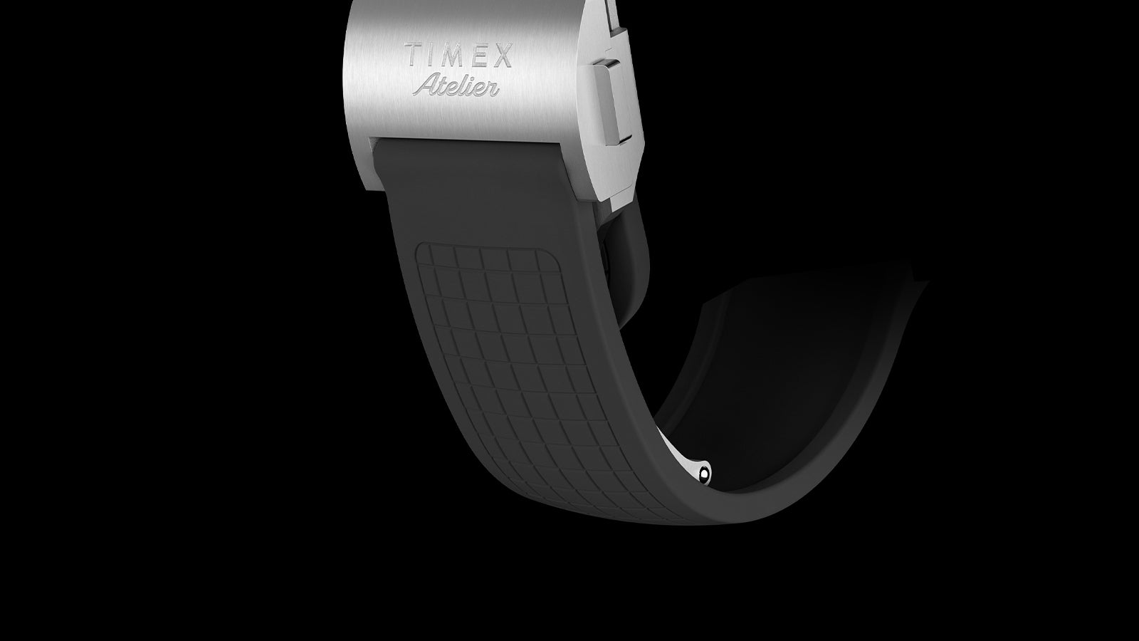 Close-up of Timex Atelier Chronograph Quartz M1a rubber strap with textured pattern and clasp engraved with Timex Atelier logo