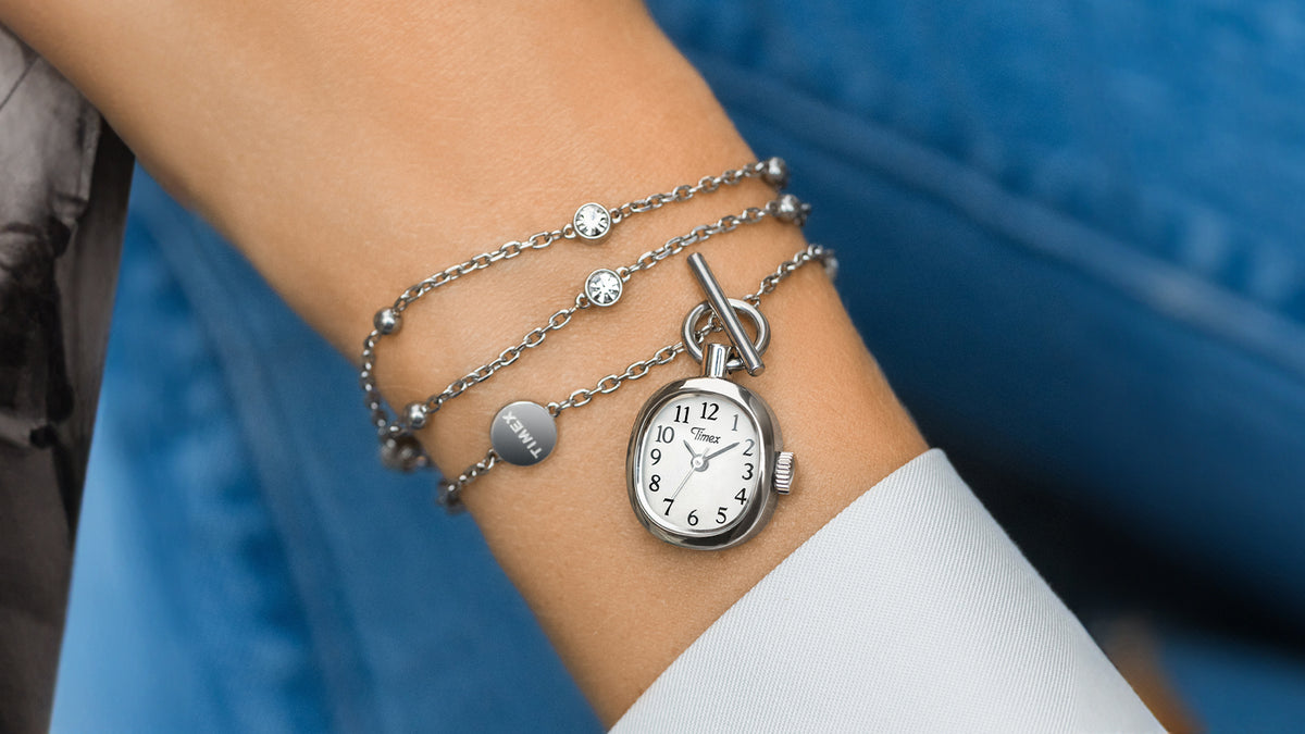 TW6A17600 Cavatina® Mini necklace wrapped around a wrist, showing its watch pendant, toggle clasp, and silver-tone chain with clear stones.