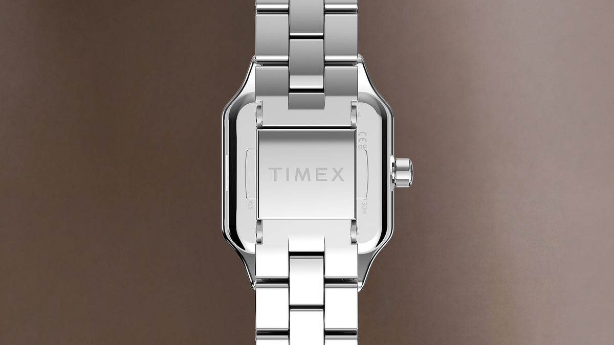 TW2Y90300 Back view of the Timex Addison watch showing its silver-tone case, link bracelet, and clasp engraved with the Timex logo.