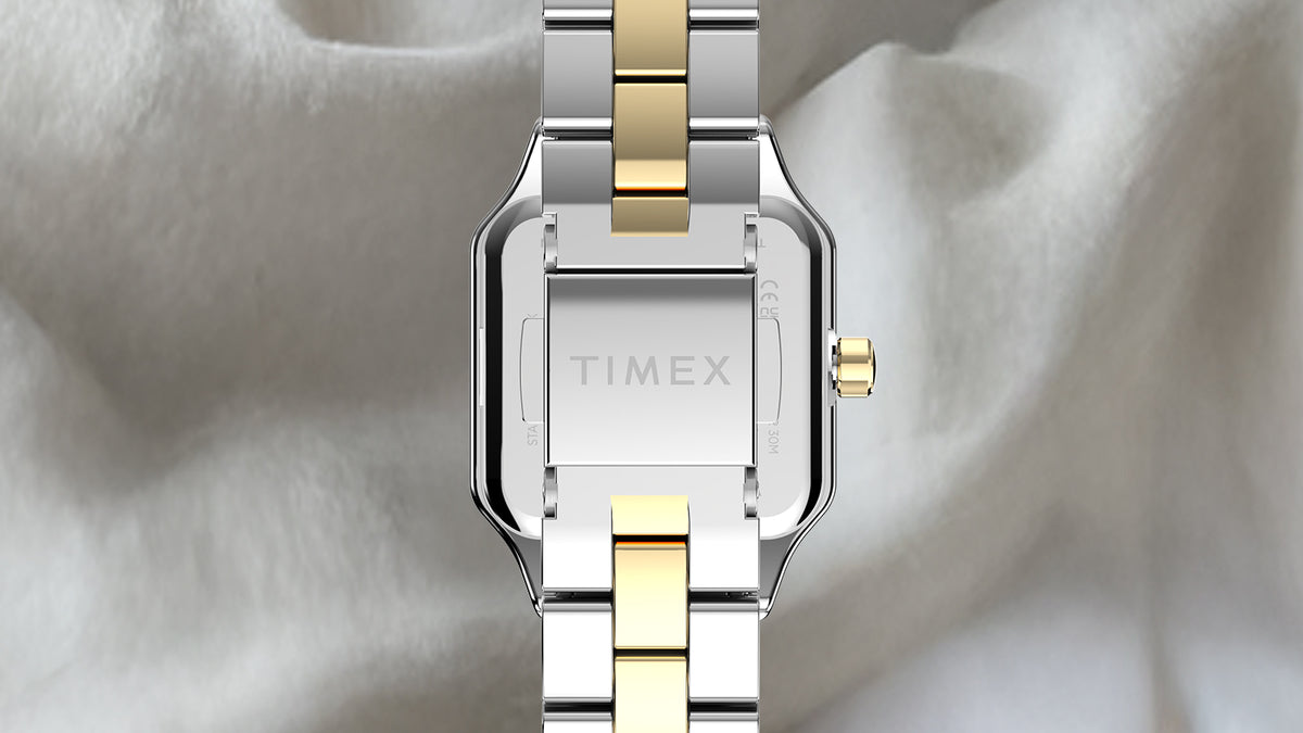 Back view of the Timex Addison watch showing its silver-tone case, two-tone bracelet, and clasp engraved with the Timex logo.