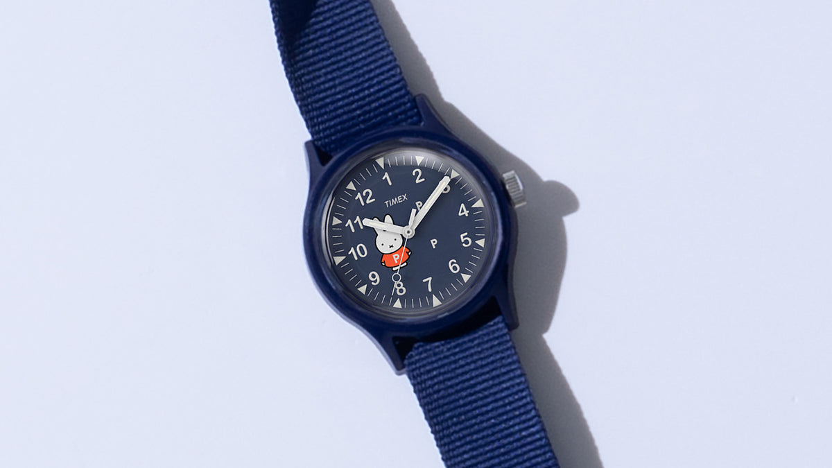 TW6A31000 Pop & Miffy by Timex MK1 watch with a navy case and fabric strap, positioned diagonally on a pale background.