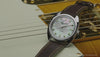 Fender x Timex watch transitions from an angled view on an electric guitar to centered front views with guitars and amplifiers in the background.