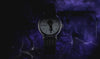 Video for the Timex x Wednesday Weekender watch collection. The video features moody, gothic visuals inspired by the Netflix "Wednesday" series. It showcases close-up shots of the watch with a striped leather strap and a dial featuring Wednesday Addams' silhouette holding an umbrella. Transitions highlight the Indiglo backlight effect, which reveals hidden gothic gate artwork on the dial.