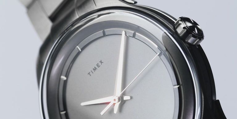 A sleek showcase of a titanium watch, featuring close-up shots highlighting its durable and lightweight metal construction. The video captures the brushed titanium case, finely crafted bracelet, and detailed watch face with luminescent hands and numerals. The watch is displayed on a model's wrist in various angles, emphasizing its modern and rugged aesthetic. Smooth camera movements and lighting enhance the premium feel of the titanium material.