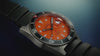 Promotional video of the Timex Deepwater Reef 200 showing close-up shots of the orange dial, rotating bezel, titanium case, and water-resistant performance. The watch is displayed emerging from water, worn by a diver, and shown glowing underwater with luminescent markers.